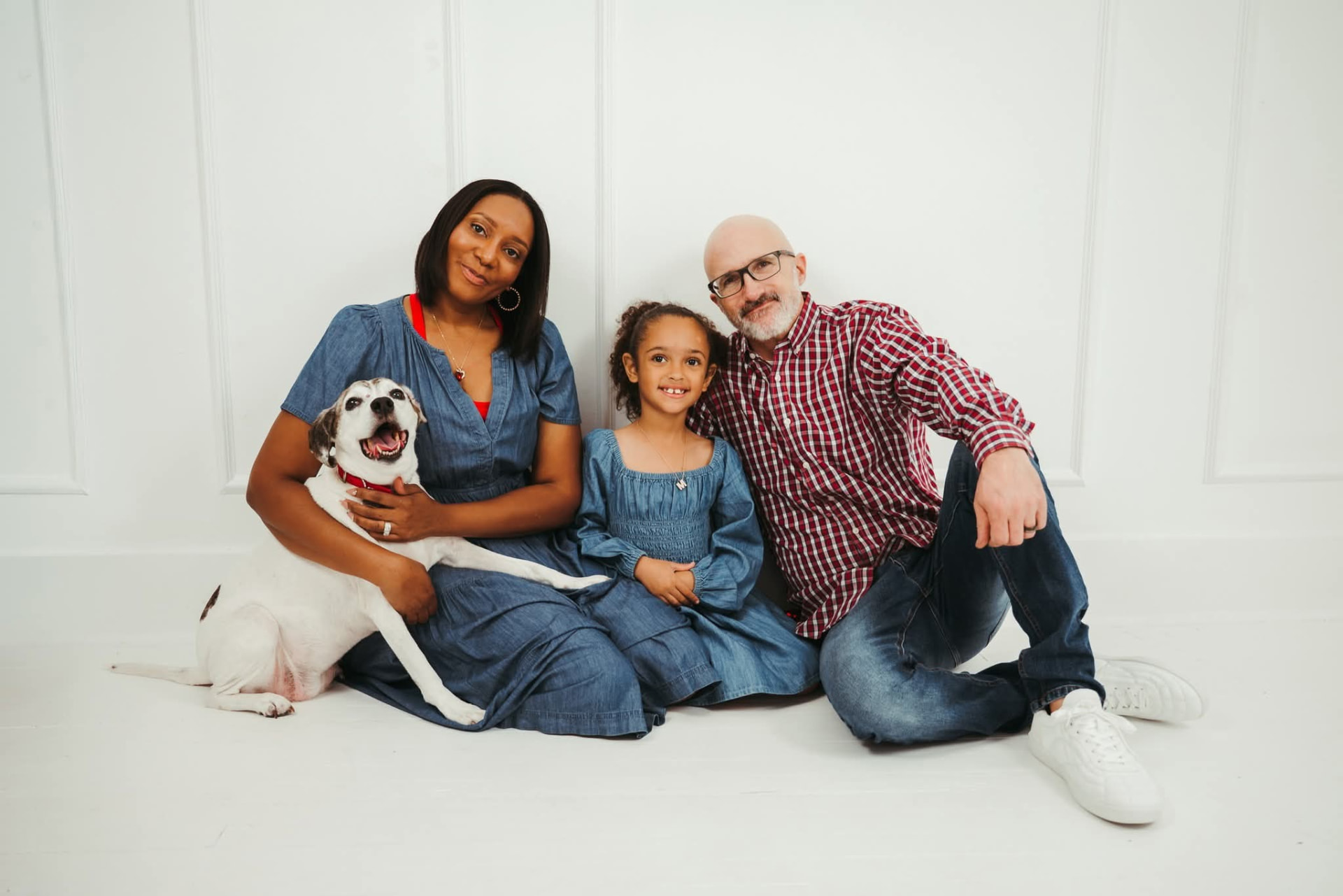 Brandy Sinclair, her daughter Mary, husband Arthur and their dog in matching denim on a white studio backdrop